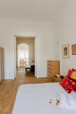 a white bedroom with a bed and a dining room at Brussels Benit Ixelles House in Brussels