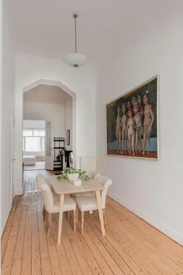 a dining room with a table and a painting on the wall at Brussels Benit Ixelles House in Brussels