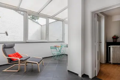 a room with a chair and a window at Brussels Benit Ixelles House in Brussels