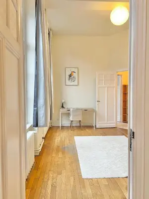 a living room with a table and a white rug at Manneken View in Brussels