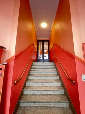 a staircase in an empty building with red walls and stairsogyn at Manneken View in Brussels