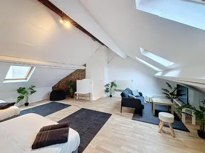 a loft conversion with a bedroom and a living room at Porte de Namur in Brussels