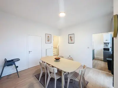 a kitchen and dining room with a table and chairs at Porte de Namur in Brussels