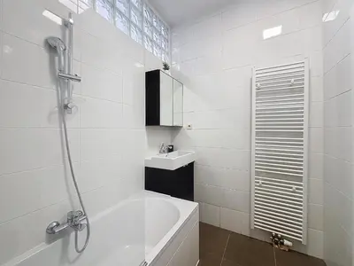 a bathroom with a shower and a tub and a sink at Porte de Namur in Brussels