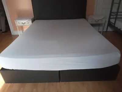 a bed with a white mattress in a room at FAMILY ROOM lux in Brussels