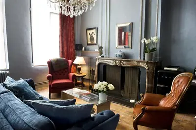 a living room with a couch and a fireplace at Ganda Rooms & Suites in Ghent