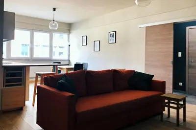 a living room with a couch and a table at Renovated one bedroom apartment Schuman area in Brussels