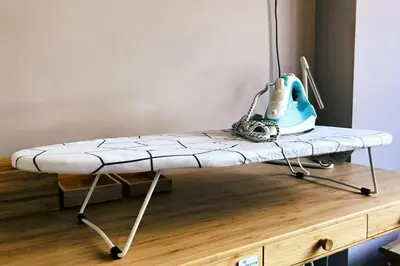 a hospital bed on a wooden table with a machine at Charming little studio in Brussels