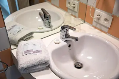 a bathroom with a sink and a mirror and a sink at Hotel The Boatel in Ghent