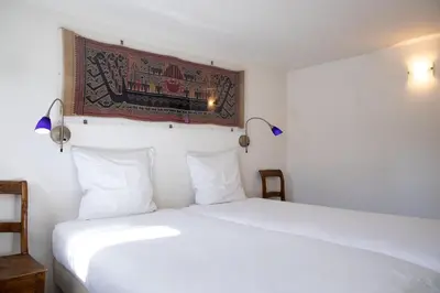 a bedroom with a white bed and a picture on the wall at Hotel The Boatel in Ghent