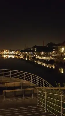 a bridge over a body of water at night at Hotel The Boatel in Ghent
