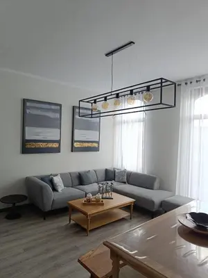 a living room with a couch and a table at Modern Triplex 140m2 - 4 bedrooms, 1 living room & 2 bathrooms - 8 people in Brussels city in Brussels