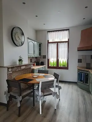a kitchen with a table and chairs in a room at Modern Triplex 140m2 - 4 bedrooms, 1 living room & 2 bathrooms - 8 people in Brussels city in Brussels