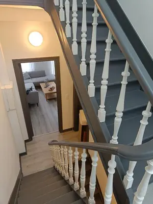 a staircase with white railings in a house at Modern Triplex 140m2 - 4 bedrooms, 1 living room & 2 bathrooms - 8 people in Brussels city in Brussels