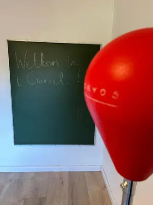 a red balloon sitting in front of a blackboard at 't Cravael in Meldert