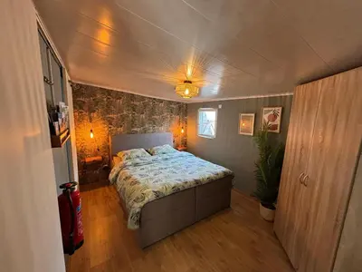a bedroom with a bed in a small room at CASA LAGO gezellige chalet aan het water in Geel