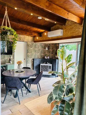a dining room with a table and chairs at CASA LAGO gezellige chalet aan het water in Geel