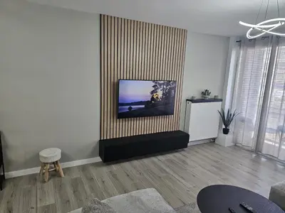 a living room with a flat screen tv on a wall at Modern Comfort Spot Apartments in Antwerp