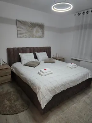 a bedroom with a large bed with two towels on it at Modern Comfort Spot Apartments in Antwerp