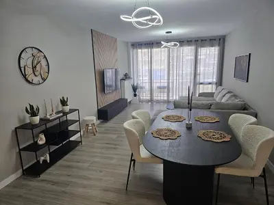 a living room with a table and a couch at Modern Comfort Spot Apartments in Antwerp
