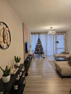 a living room with a christmas tree in the background at Modern Comfort Spot Apartments in Antwerp