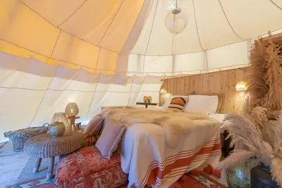 a bedroom with a bed in a tent at Tipi Marie met hotutub in de tuin in Kaprijke