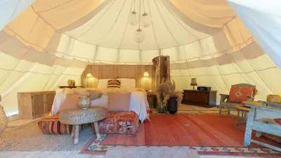 a bedroom with a bed in a tent at Tipi Marie met hotutub in de tuin in Kaprijke