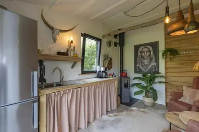 a kitchen with a counter with a sink and a kitchen sidx sidx at Tipi Marie met hotutub in de tuin in Kaprijke