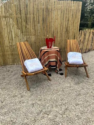 a table and two chairs with a table at Tipi Marie met hotutub in de tuin in Kaprijke