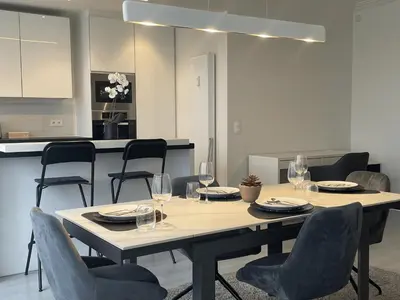 a dining room table and chairs with wine glasses at Chez HN Confort et Style in Edegem