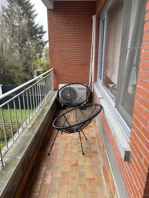 a balcony with two chairs and a window at Chez HN Confort et Style in Edegem
