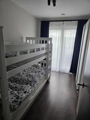a bedroom with two bunk beds and a window at Homeawayfromhomeghent with private parking in Ghent