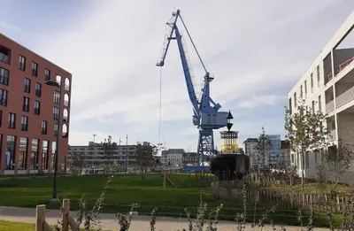 a large crane in the middle of a city at Homeawayfromhomeghent with private parking in Ghent