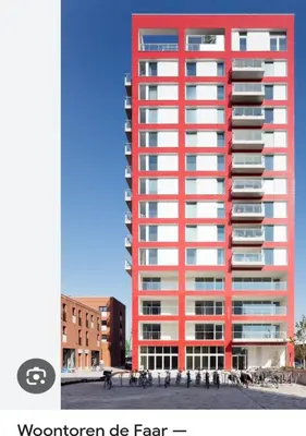 a tall red building with people in front of it at Homeawayfromhomeghent with private parking in Ghent