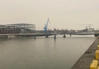 a bridge over a body of water with a building at Homeawayfromhomeghent with private parking in Ghent