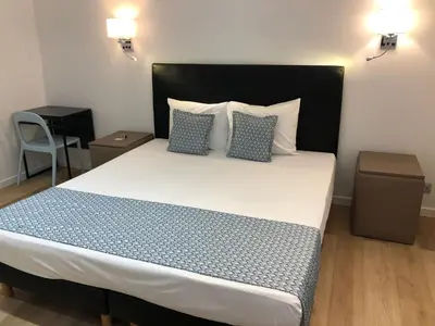 a bedroom with a large bed with two pillows at Shelter-rooms in Buysinghen