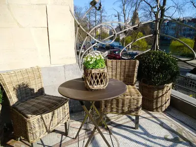a small table and chairs with a potted plant on it at Maison Flagey Brussels in Brussels