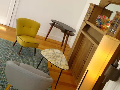 a living room with a chair and a table at Maison Flagey Brussels in Brussels