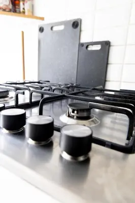 a stove top with four burners on it in a kitchen at Appartement confortable avec garage premier étage sans terrasse in Brussels