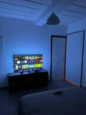 a room with a television with a blue light at Appartement de Luxe Entièrement Rénové - Proche Aéroport de Bruxelles, Quartier Chic in Brussels