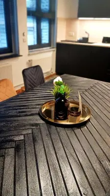 a plate with a flower on top of a table at Royal South II - Stylish apartment in Antwerp Zuid in Antwerp