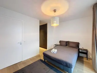 a bedroom with a bed with two stuffed animals on it at Penthouse Cinquantenaire in Brussels