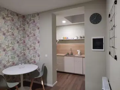 a kitchen with a table and a clock on the wall at City Center location 1BR Apartment near Station! in Antwerp