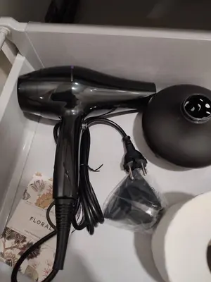 a black hair dryer sitting next to a computer mouse at City Center location 1BR Apartment near Station! in Antwerp