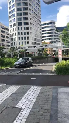 a car driving down a city street with tall buildings at City Center location 1BR Apartment near Station! in Antwerp