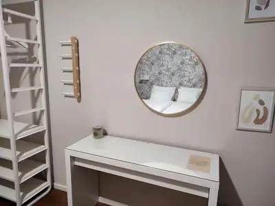 a white dressing table with a mirror on a wall at City Center location 1BR Apartment near Station! in Antwerp