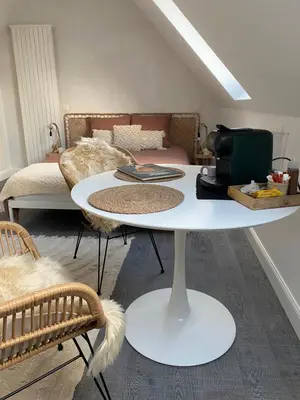 a white table in a room with a bed at The Conservatory, a cosy private attic located central between Ghent Antwerp Brussels in Lokeren