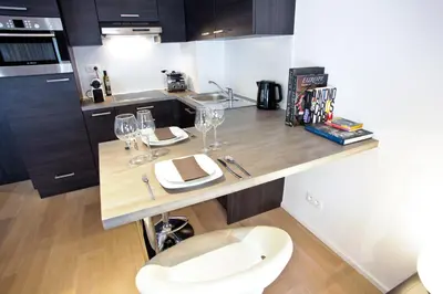 a kitchen with a counter with wine glasses on it at Flat Moliere in Brussels