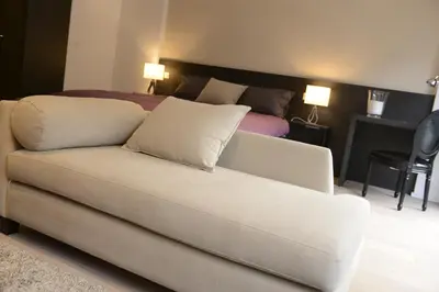 a living room with a couch and a bed at Flat Moliere in Brussels
