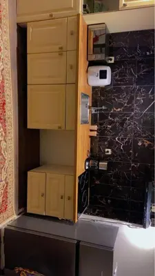 a kitchen with wooden cabinets and a counter top at Coumbis Faye in Brussels